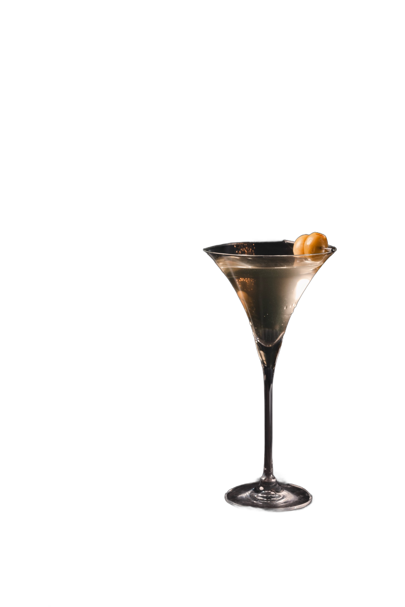 Martini with olives on a lounge table, low light