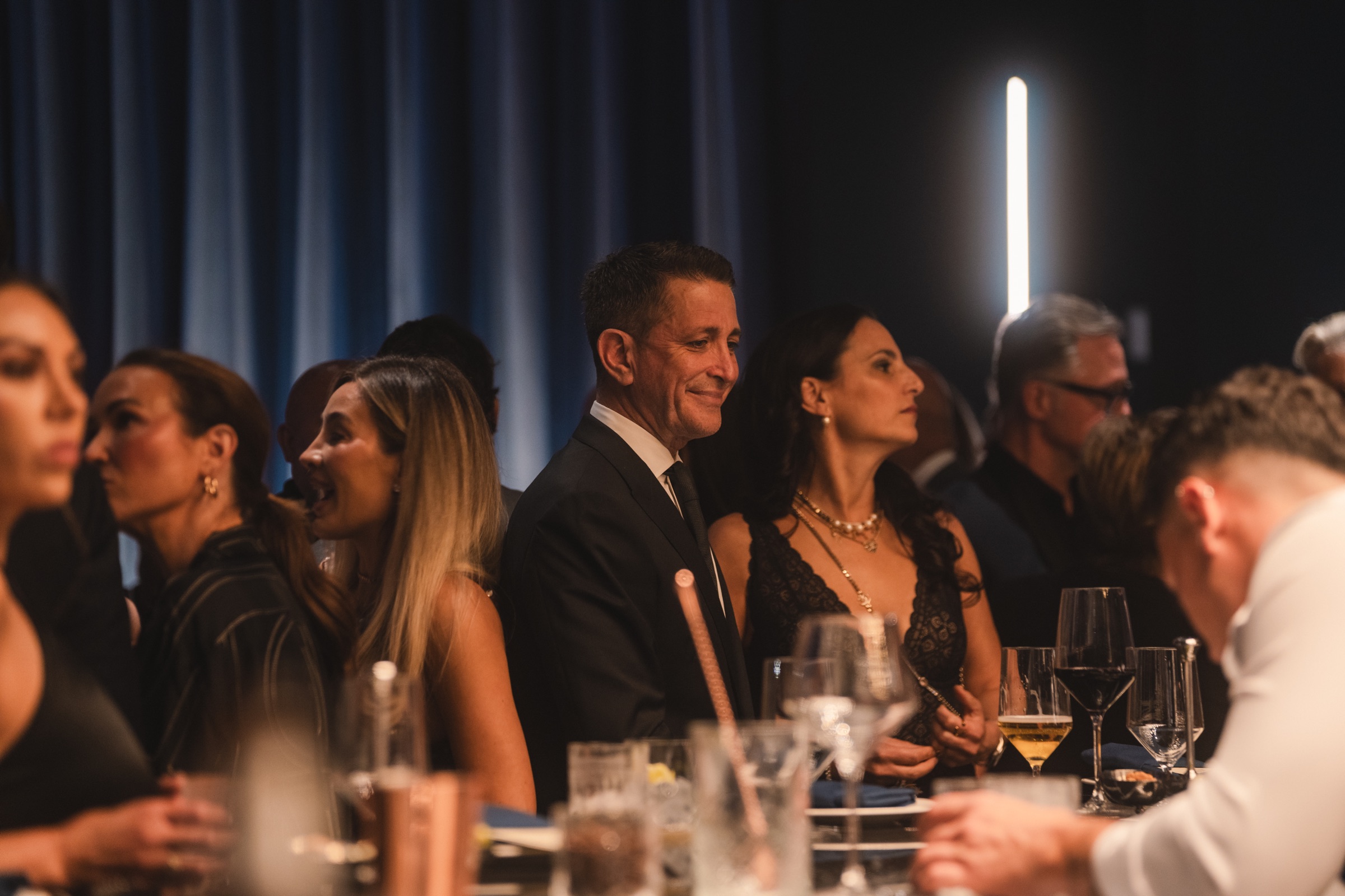 Guests enjoying dinner in a softly lit private dining room
