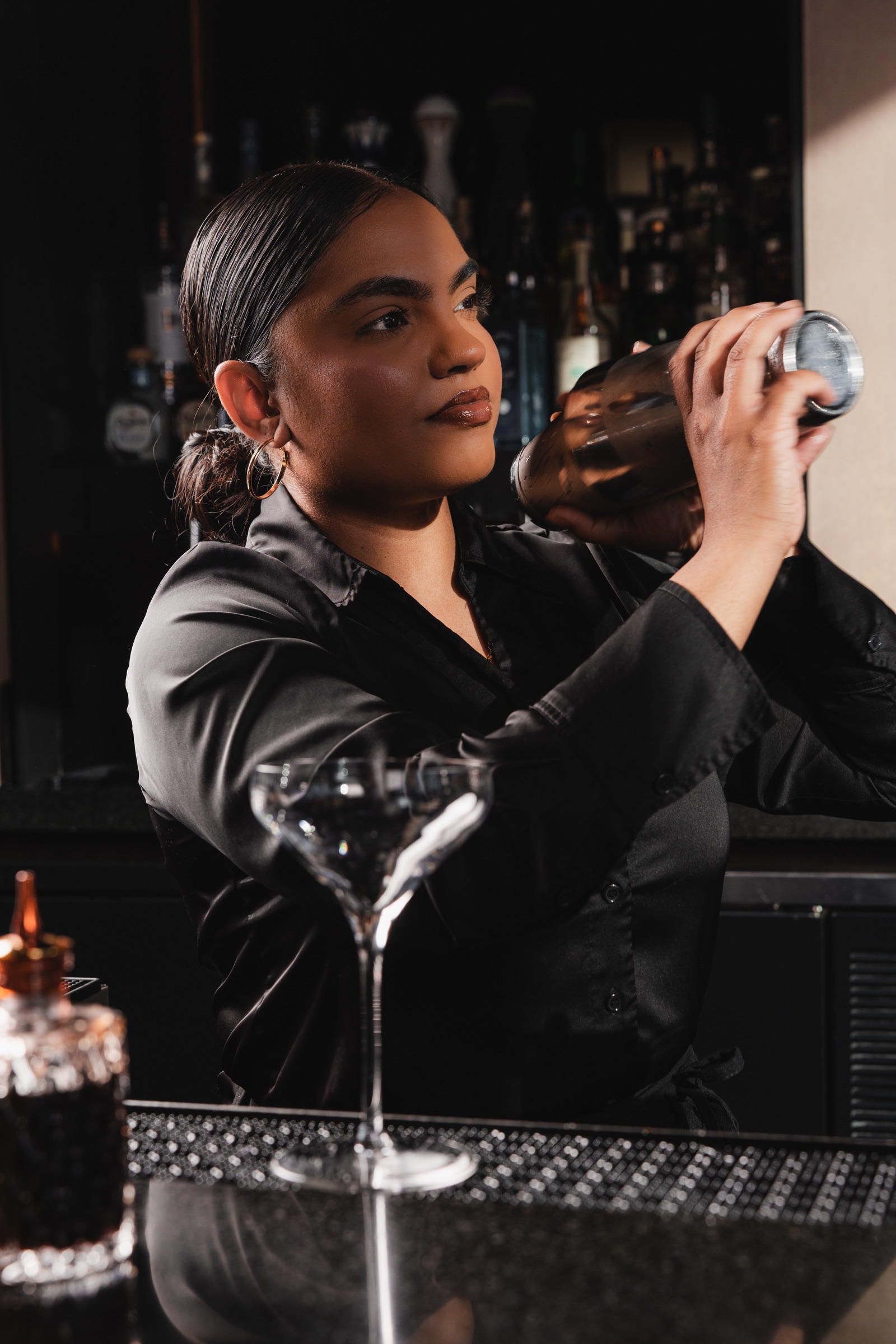 Bartender shaking a cocktail behind the bar