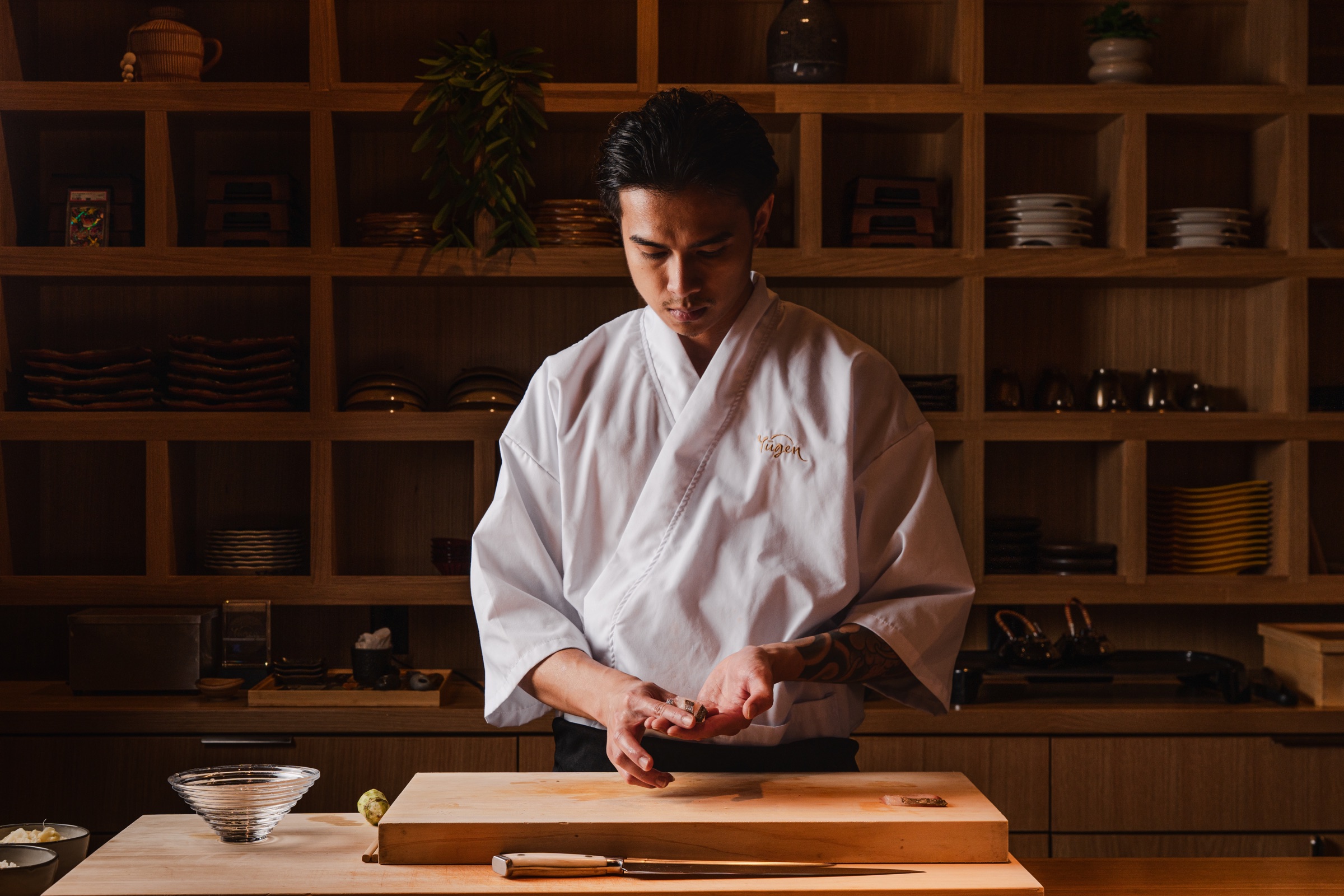 Chef preparing ingredients at a wooden counter